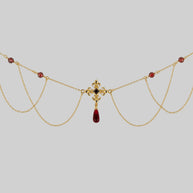 gold draped chain necklace with red gemstones