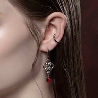 Silver knotted dangle earrings with red droplet