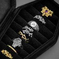 black velvet coffin case with silver gold rings close up